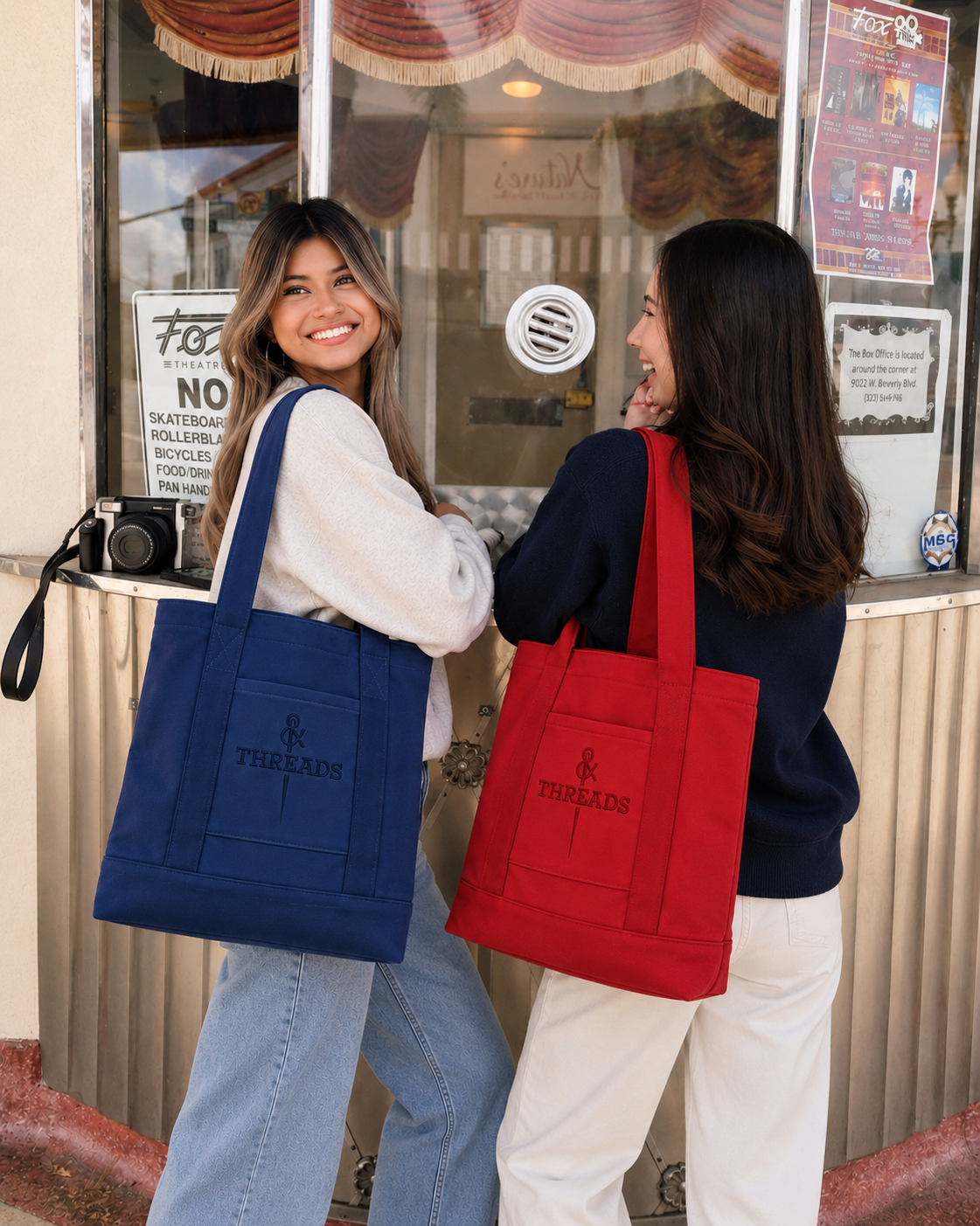 Two models carrying navy and red BOLD totes