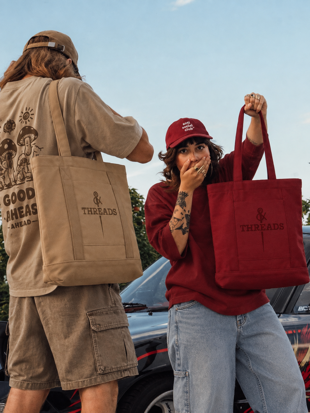 Two models carrying camel and burgundy BOLD totes